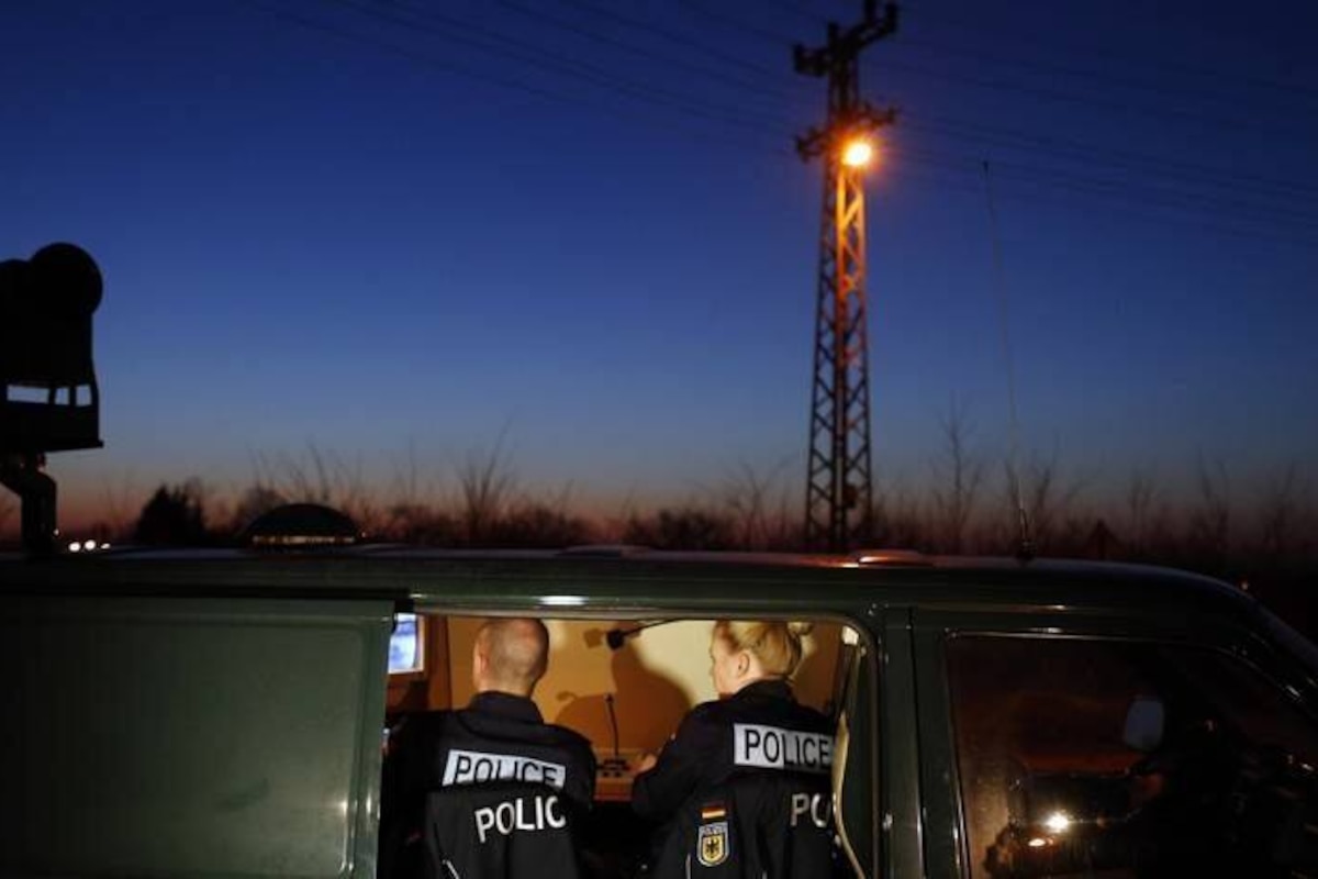 FILE - In this Feb 13, 2015 file photo members of the German border police sit in a van as they check a security camera while monitoring a stretch of the Serbian border with Hungary in the village of Hajdukovo, some 180 kilometers north of Belgrade, Serbia. Hungary's foreign minister said Wednesday, June 17, 2015 the government is considering building a 4-meter-high (13-foot-high) fence along border with Serbia to stop the flow of migrants reaching the country. (AP Photo/Darko Vojinovic)