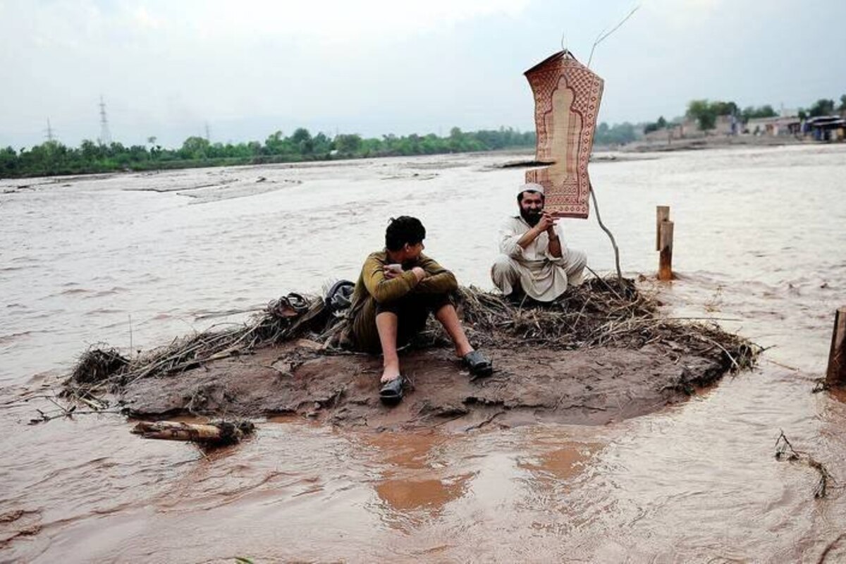 PESHAWAR, PAKISTAN - APRIL 5: Pakistanis walk in flood water after a heavy rainfall caused Bara River to overflow in the Batatel district of Peshawar, Pakistan on April 5, 2016. Metin Aktas / Anadolu Agency Reporters / Abaca