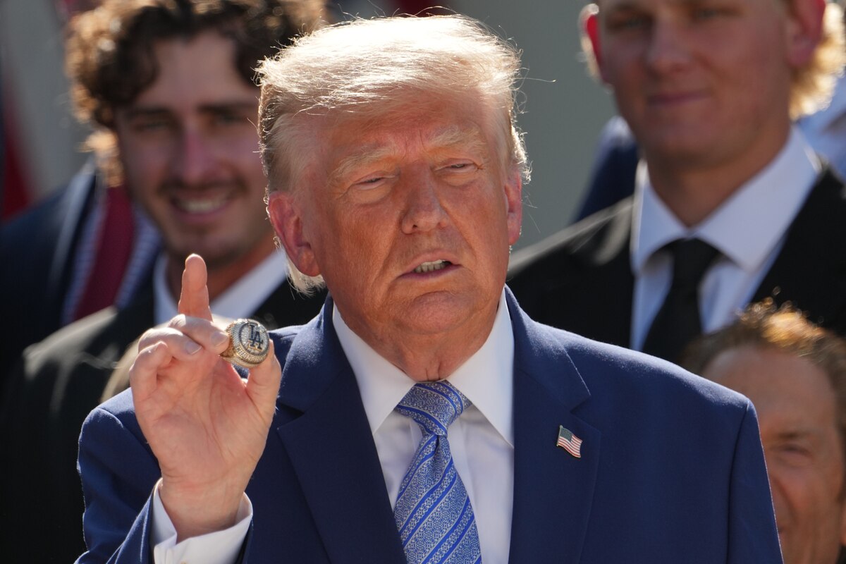 President Donald Trump holds a championship ring during an event to honor the 2025 World Series champions Los Angeles Dodgers in the Rose Garden of the White House, Thursday, July 23, 2026, in Washington. (AP Photo/Alex Brandon)