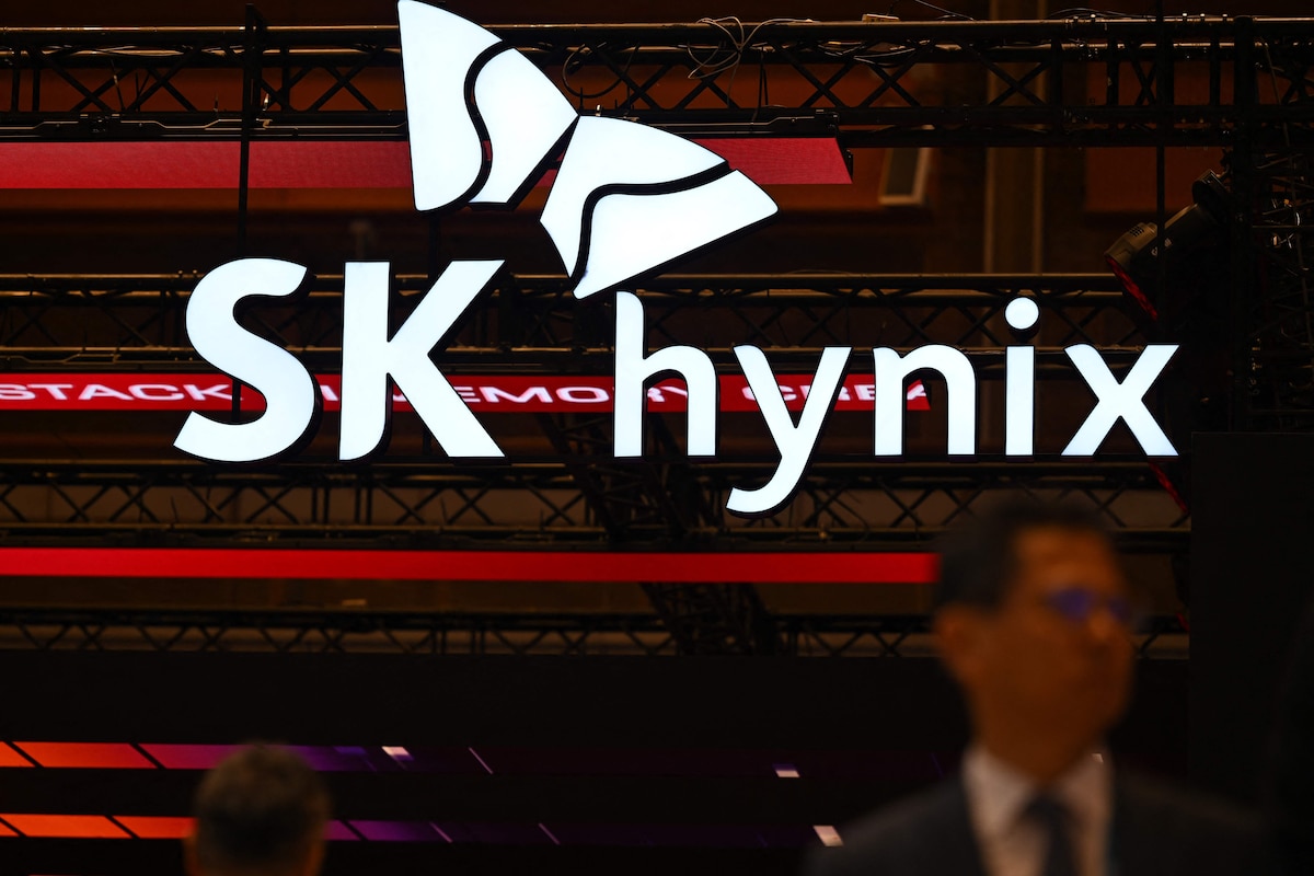 A man walks past the logo of SK hynix during a semiconductor exhibition at the COEX convention and exhibition centre in Seoul on October 14, 2026. (Photo by Jung Yeon-je / AFP)