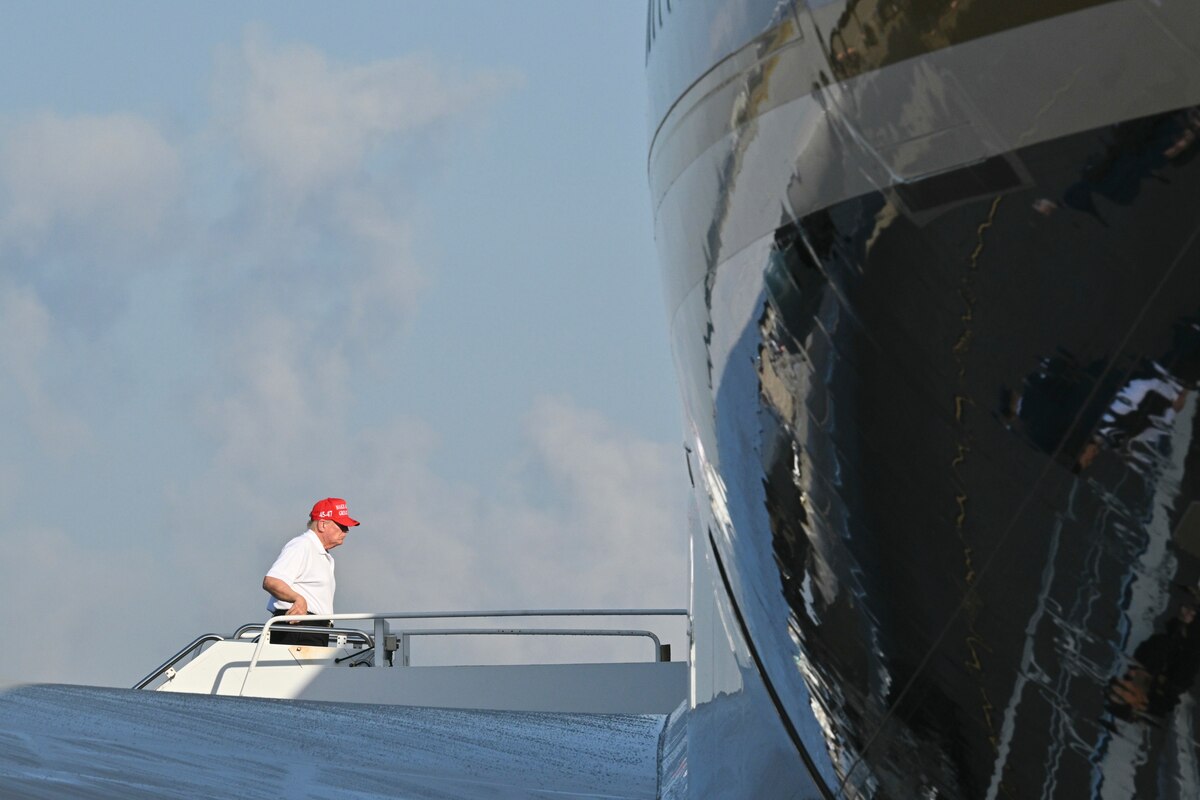 President Donald Trump boards Air Force One at Palm Beach International Airport, Wednesday, Feb. 19, 2025, in West Palm Beach, Fla., enroute to Miami. (Pool Image via AP)