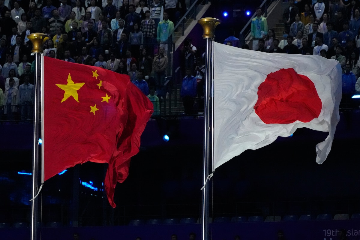 FILE -The flags of China and Japan are flown at the during the handover ceremony from China to Japan the next host of the Asian Games at the closing ceremony of the 19th Asian Games in Hangzhou, China, Sunday, Oct. 8, 2023. (AP Photo/Eugene Hoshiko, File)