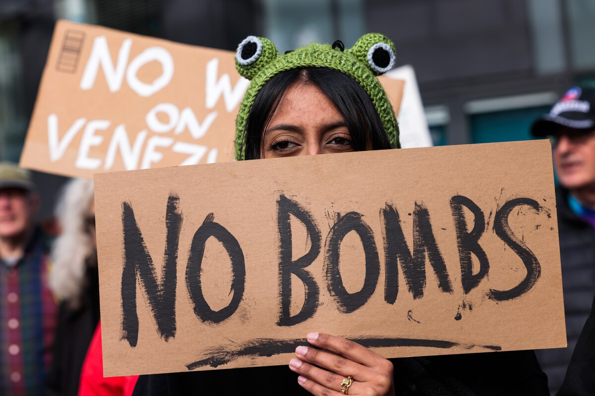 F.S. of Berkeley holds a sign stating "No Bombs" during a protest against the. U.S. bombing of Venezuela and seizure of President Nicolás Maduro in San Francisco on Saturday, Jan. 3, 2026. (Yalonda M. James/San Francisco Chronicle via AP)