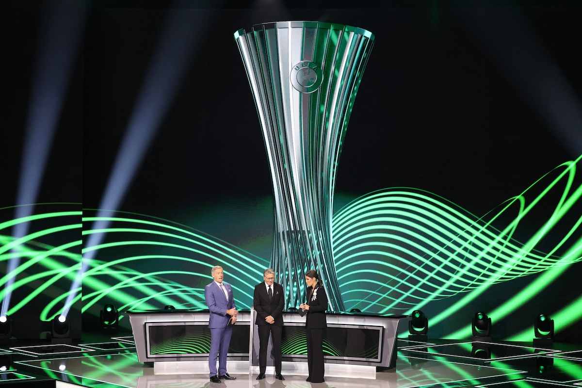 Turkish former footballer Metin Tekin (C) flanked by hosts Becky Ives (R) and Matt Smith
(L) attends the draw ceremony for the league phase of the 2026-2027 UEFA Conference League football tournament at the Grimaldi Forum in the Principality of Monaco on August 28, 2026. (Photo by Valery HACHE / AFP)