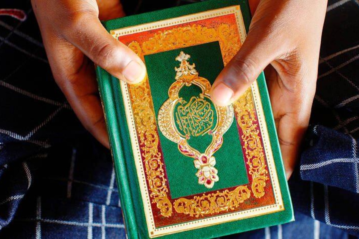 Young african boy reading the Koran.