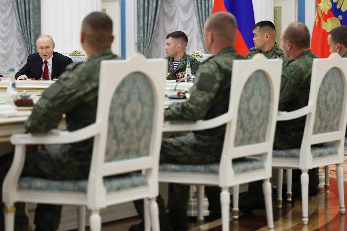In this pool photograph distributed by the Russian state agency Sputnik, Russia's President Vladimir Putin (L) attends a meeting with Russian servicemen, involved in the so-called 'special military operation' in Ukraine, in Moscow on June 12, 2026. Ukrainian drone strikes, which have intensified in recent months, are aimed at �sowing division� within Russian society and �damaging� the economy, Vladimir Putin said on June 12, 2026, though he insisted that they �will not succeed�. (Photo by Viacheslav PROKOFIEV / POOL / AFP)