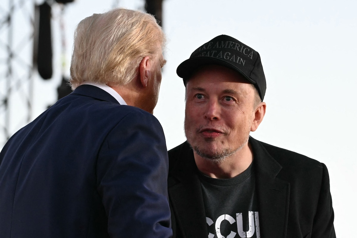Tesla CEO Elon Musk (R) joins former US President and Republican presidential candidate Donald Trump during a campaign rally at site of his first assassination attempt in Butler, Pennsylvania on October 5, 2024. (Photo by Jim WATSON / AFP)